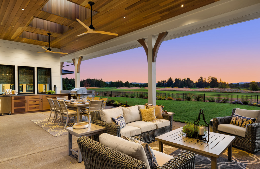 Luxury backyard oasis with an outdoor kitchen, covered porch, and seating area