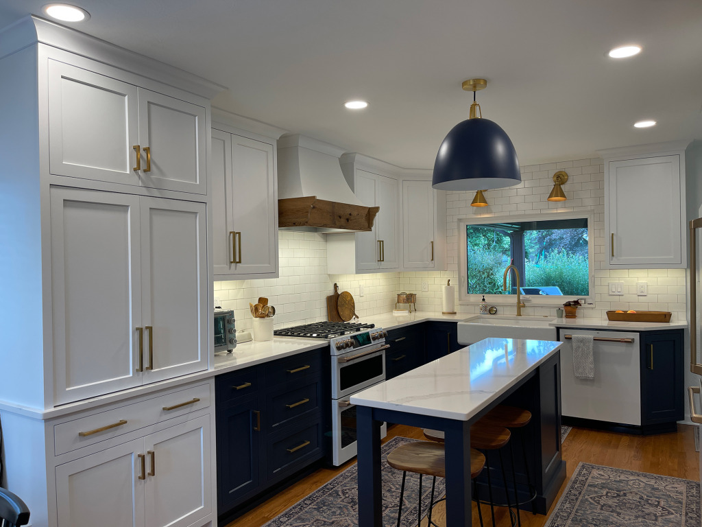 Modern kitchen with white cabinets and stone countertops built by Action Builders in Pittsburgh