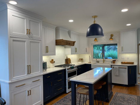 Modern kitchen with white cabinets and stone countertops built by Action Builders in Pittsburgh
